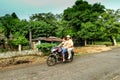 Couple on a motor bike on a dirt road